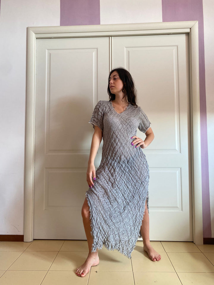 A woman wearing a light gray textured midi dress 