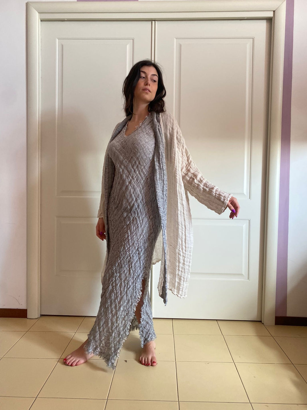 A woman wearing a light gray textured midi dress 