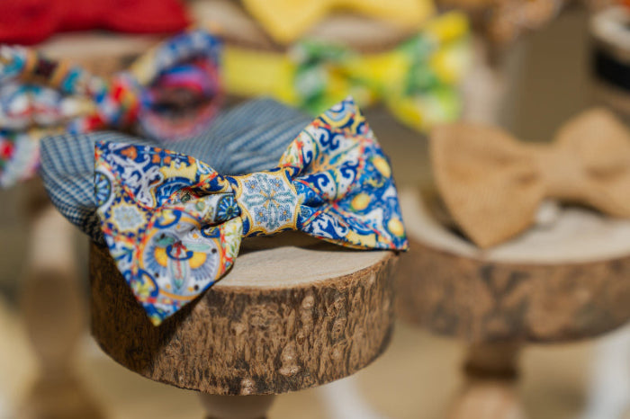 Colorful bow tie on a wooden stand with blurred background